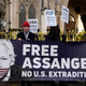 Supporters of WikiLeaks founder Julian Assange, hold placards outside the Royal Courts of Justice in London on December 10, 2021.